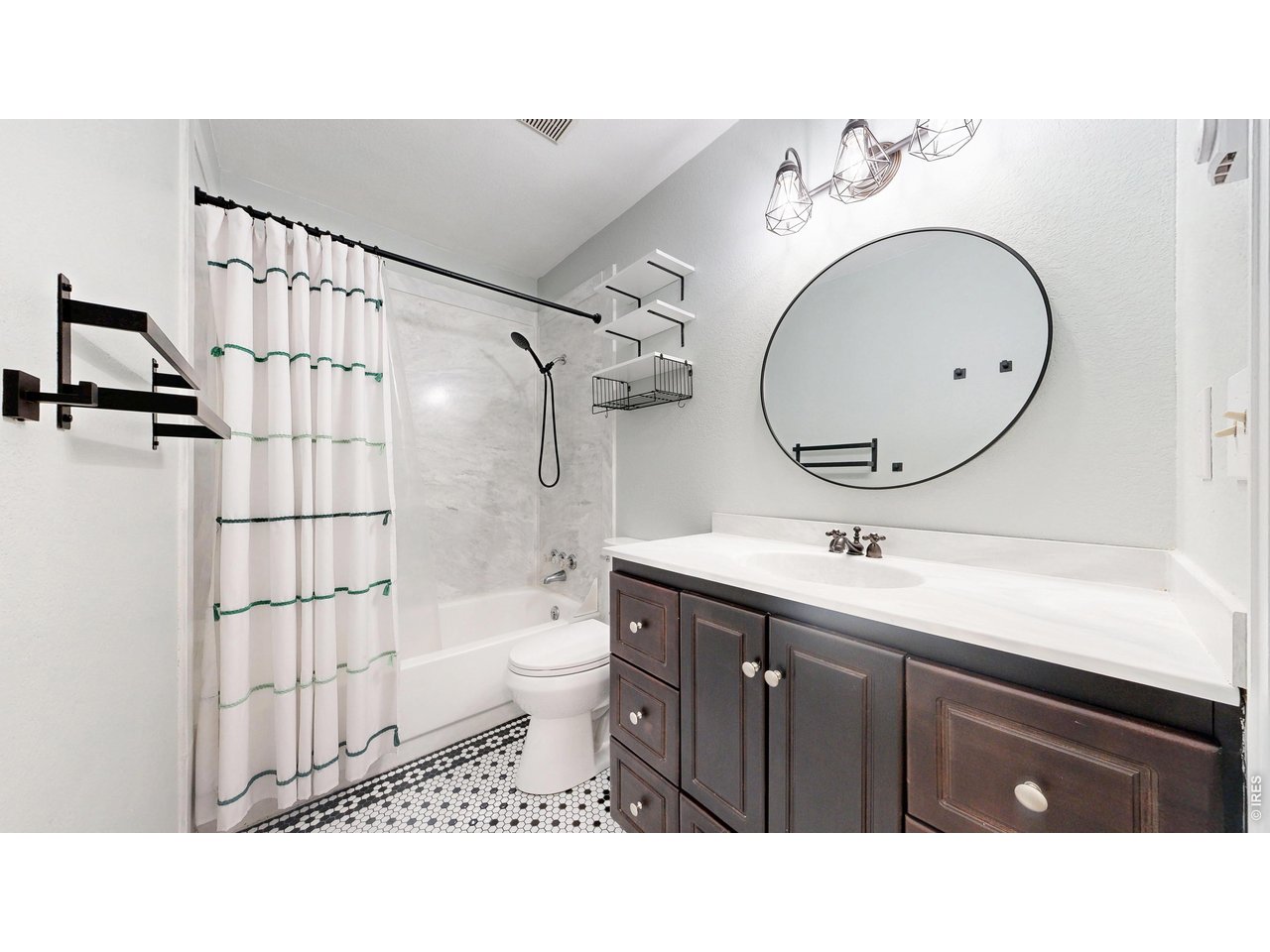 1440 Edora Road, Unit 19 Fort Collins, CO 80525 - Photo 19 of 30 Upstairs full bathroom with a stylish round mirror, updated fixtures, and a tub-shower combo