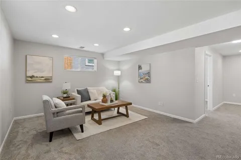 a living room with furniture and a night stand