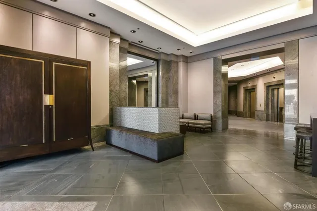 a lobby with furniture and a large mirror