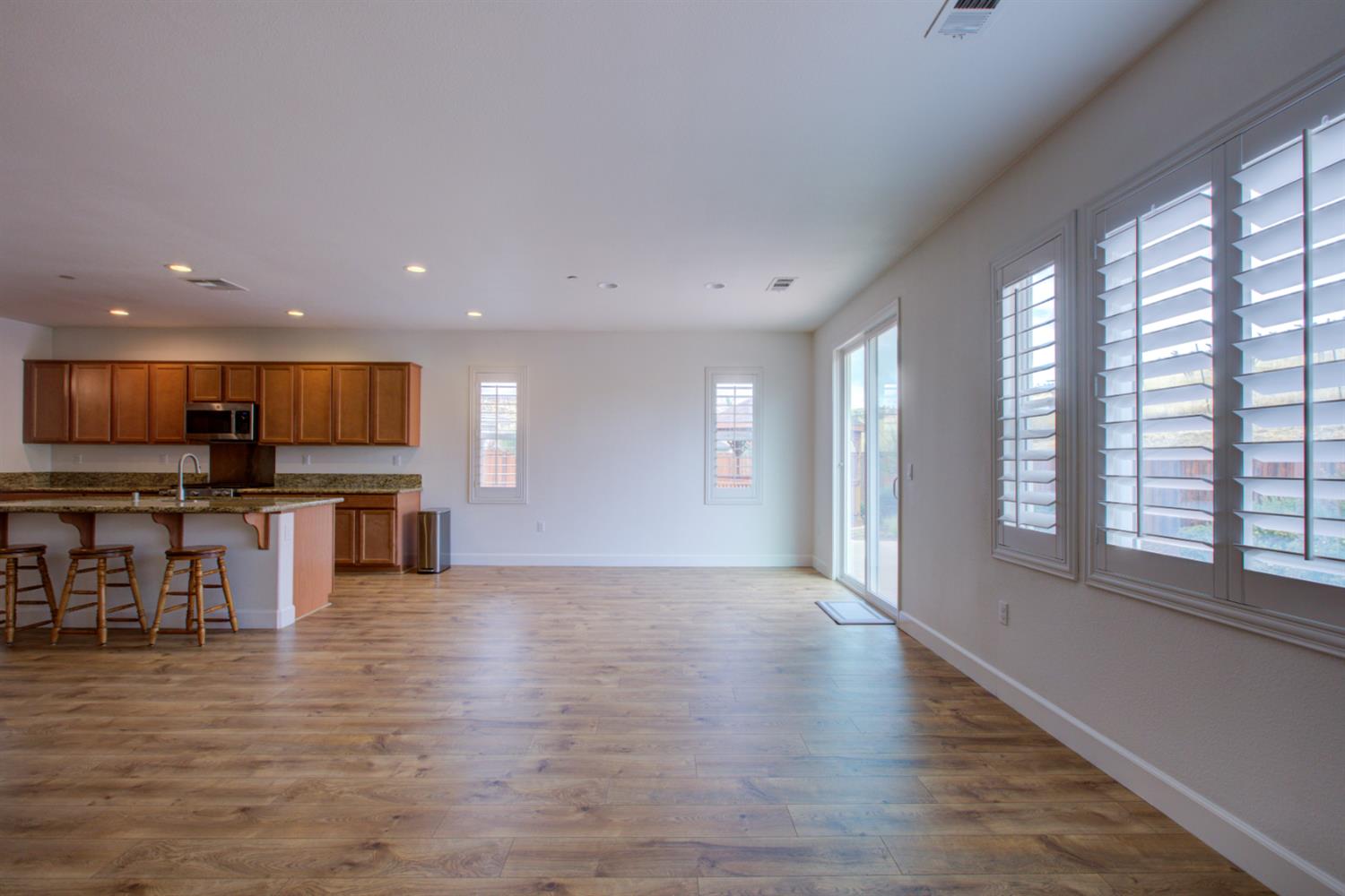21100 Varietal Court Patterson, CA 95363 - Photo 16 of 55 a view of kitchen with furniture and wooden floor
