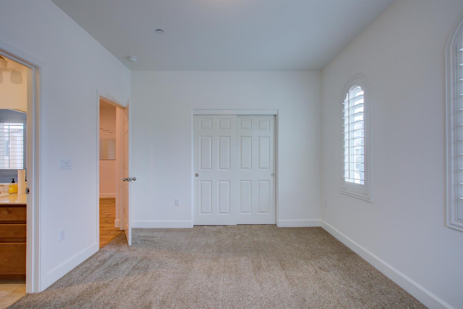 21100 Varietal Court Patterson, CA 95363 - Photo 23 of 55 an empty room with windows and closet