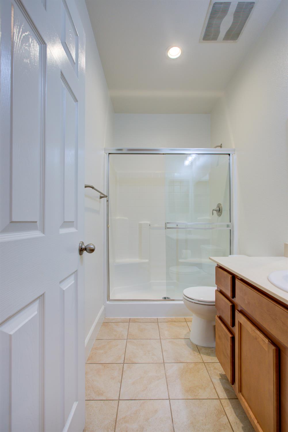 21100 Varietal Court Patterson, CA 95363 - Photo 31 of 55 a bathroom with a sink a toilet and shower
