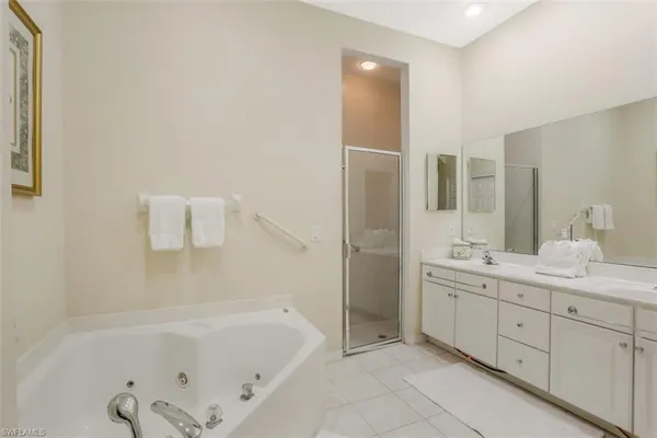 a bathroom with a tub sink and mirror