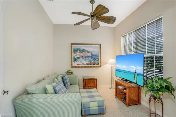 a living room with furniture plant and a window