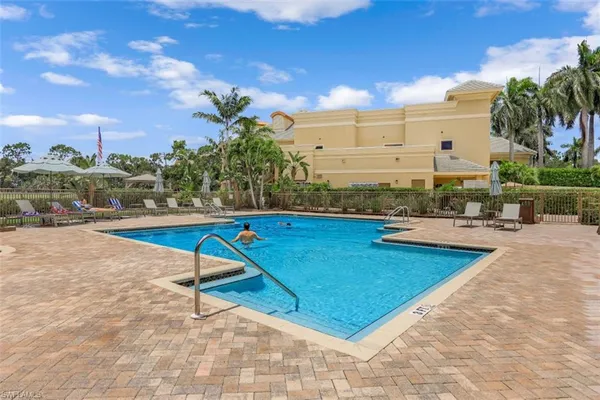 a view of a swimming pool with outdoor seating