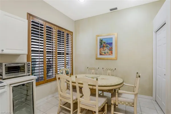 a dining room with furniture and window