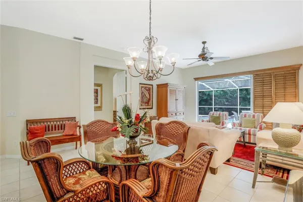 a living room with furniture a window and a chandelier