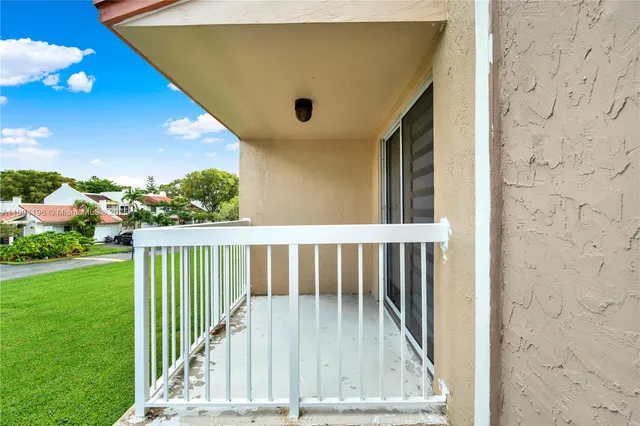 a view of balcony with wooden floor