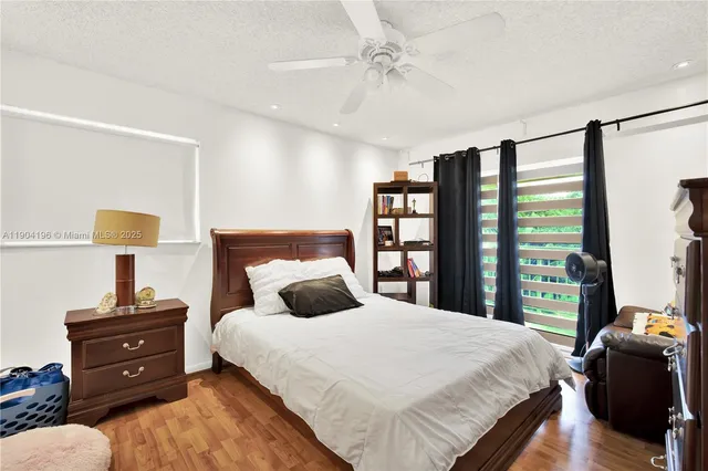 a bedroom with a bed and a lamp