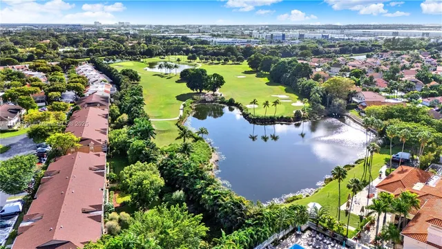 an aerial view of residential houses with outdoor space and river view