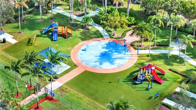 an aerial view of a play ground with swimming pool and green space