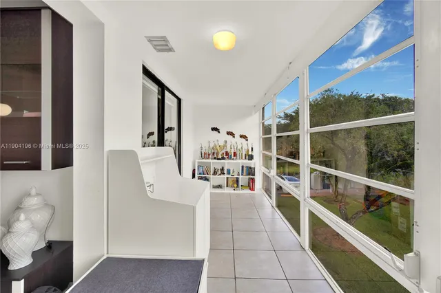a view of a hallway with furniture and chandelier