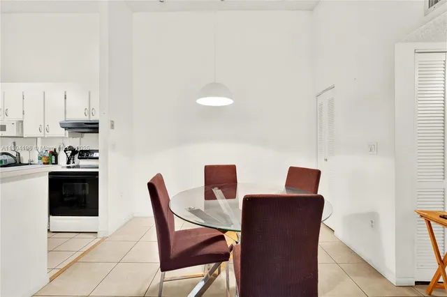 a dining room with furniture and a wooden floor