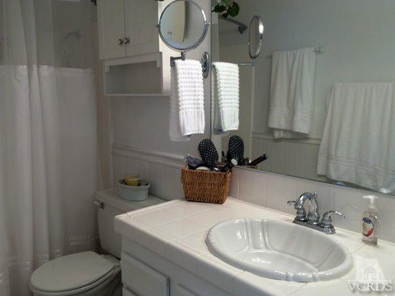 424 Reed Way Port Hueneme, CA 93041 - Photo 53 of 68 a bathroom with a sink a toilet and a mirror