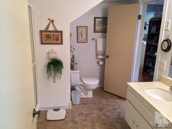 424 Reed Way Port Hueneme, CA 93041 - Photo 10 of 68 a white toilet sitting next to a bathroom sink and tub