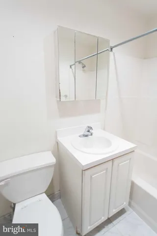 a bathroom with a sink a toilet and a shower