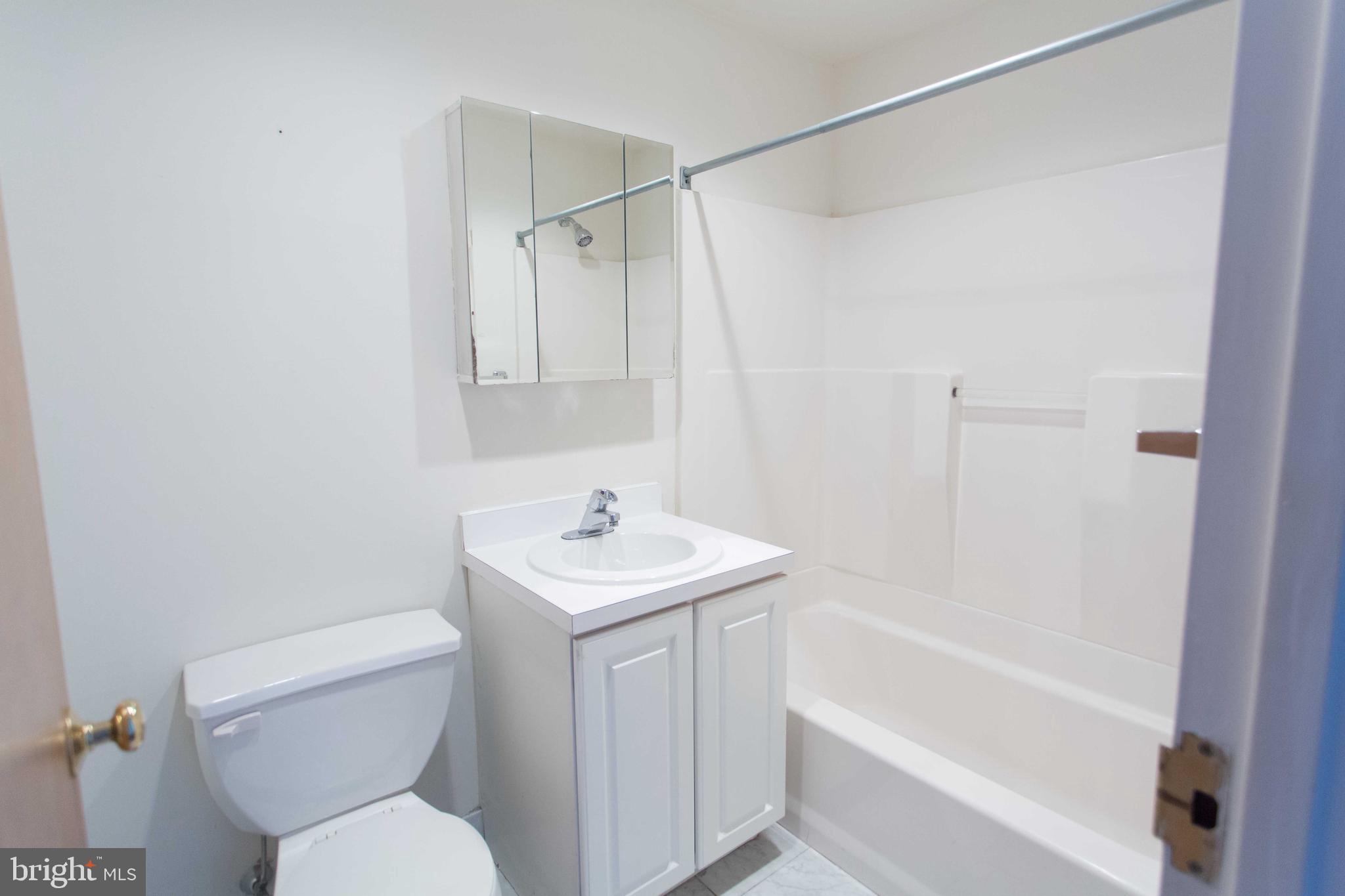 1411-3 Walnut Street, Unit 506 Philadelphia, PA 19102 - Photo 12 of 23 a white toilet sitting next to a bath tub