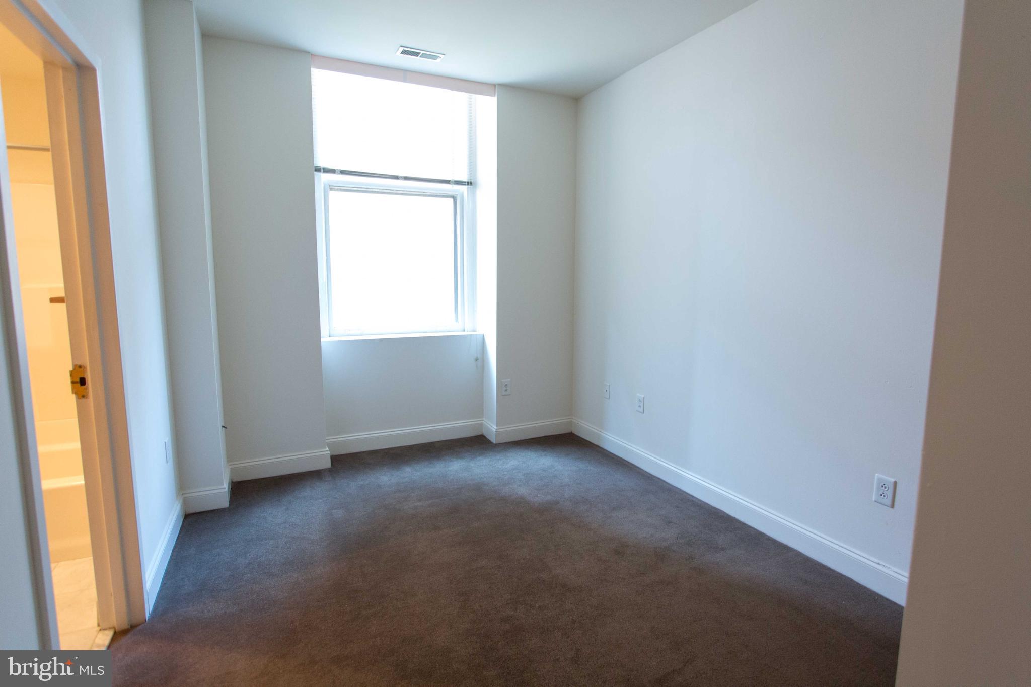 1411-3 Walnut Street, Unit 506 Philadelphia, PA 19102 - Photo 17 of 23 an empty room with a window