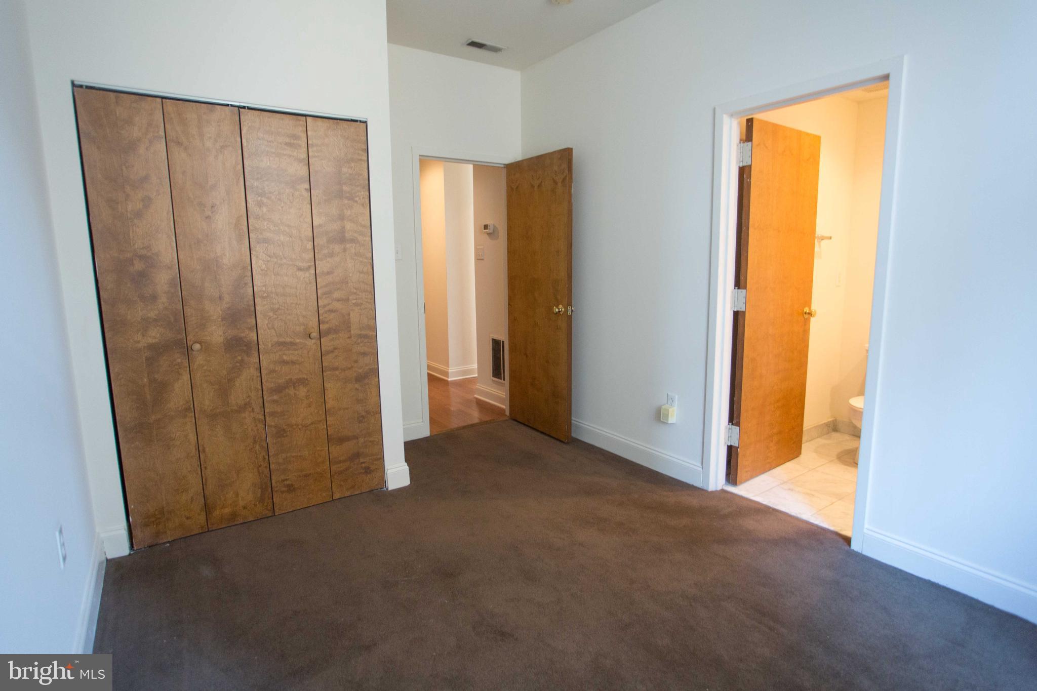 1411-3 Walnut Street, Unit 506 Philadelphia, PA 19102 - Photo 18 of 23 an empty room with windows