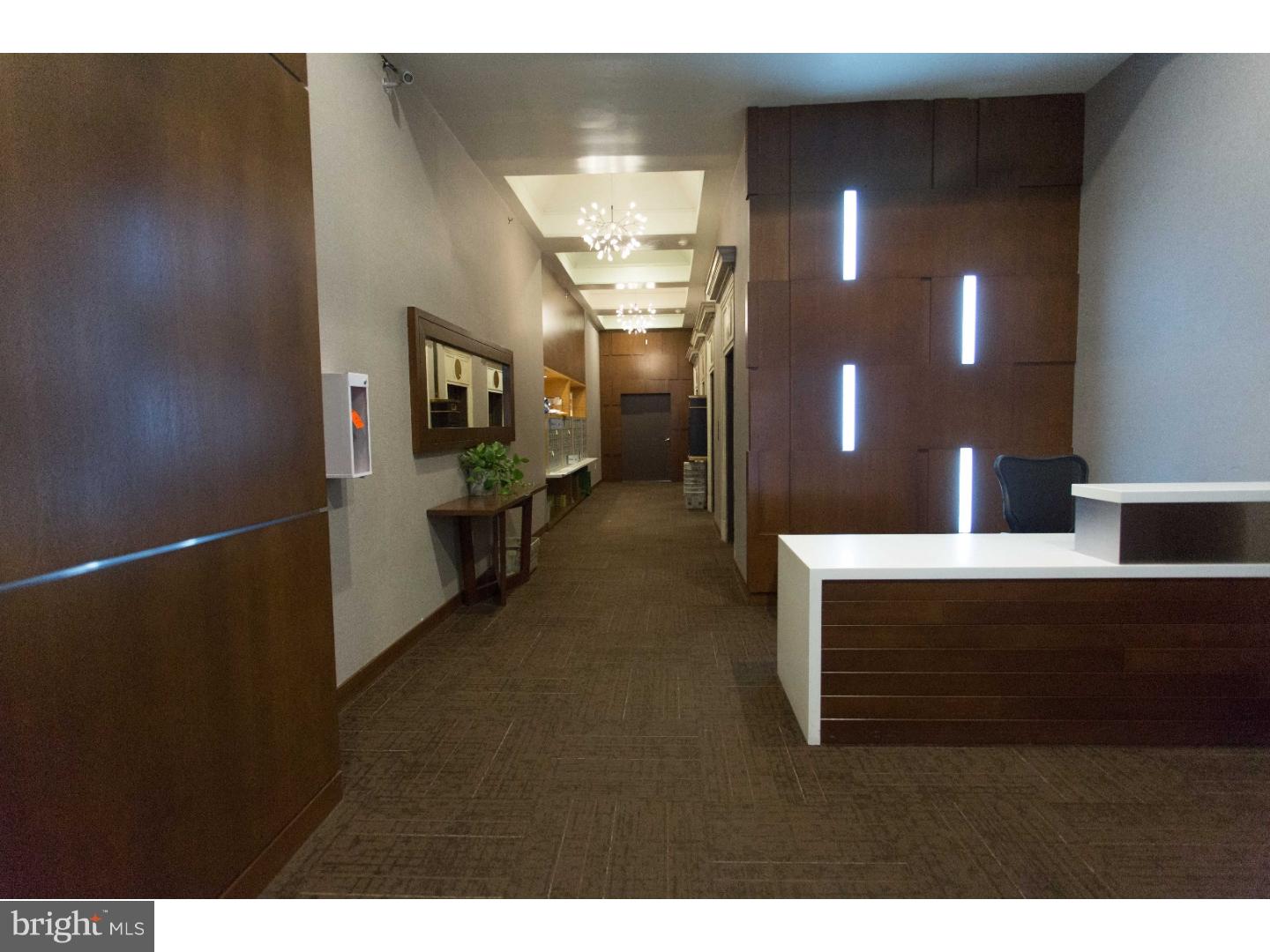 1411-3 Walnut Street, Unit 506 Philadelphia, PA 19102 - Photo 2 of 23 a view of hall way with mirror