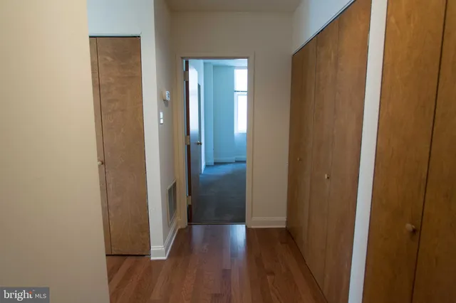 a view of a hallway with wooden floor