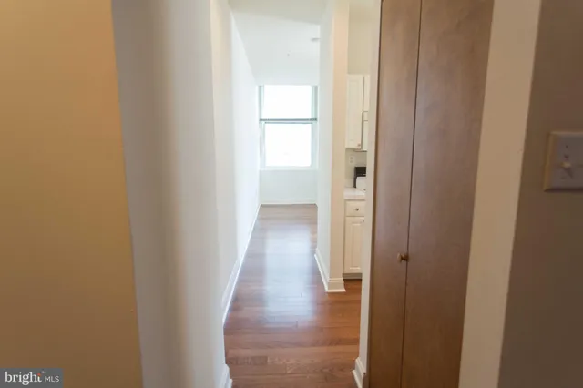 a view of a hallway with wooden floor