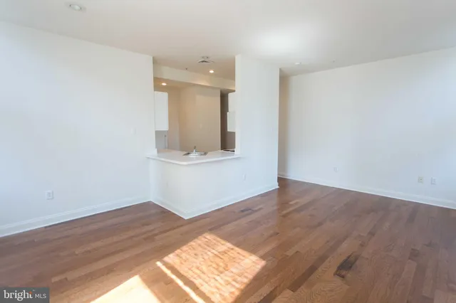 a view of an empty room and wooden floor