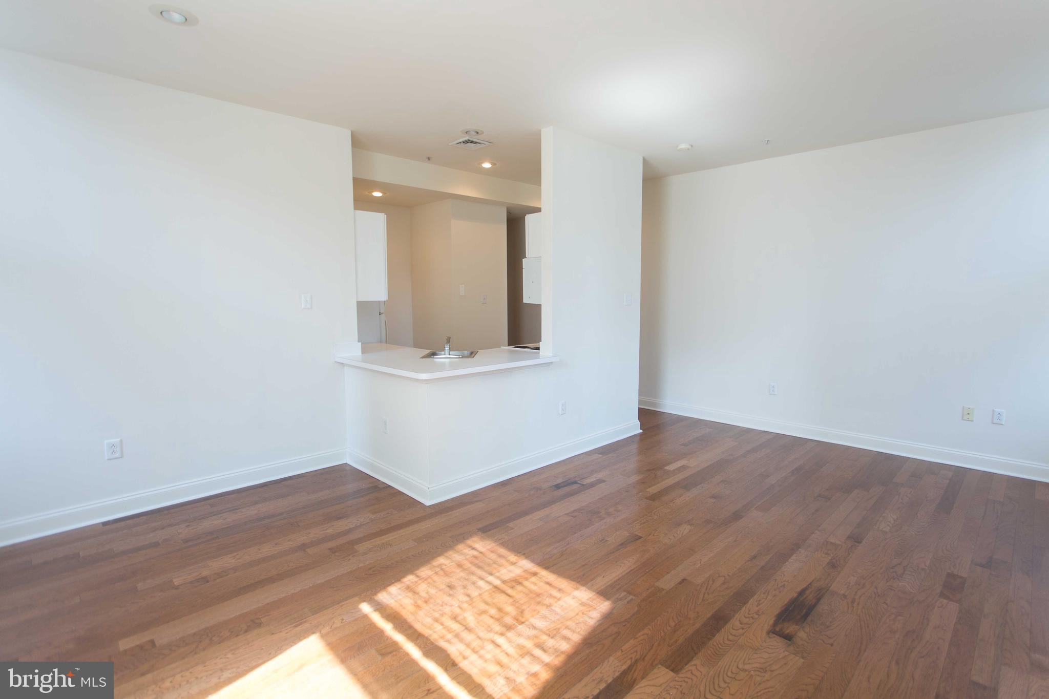 1411-3 Walnut Street, Unit 506 Philadelphia, PA 19102 - Photo 6 of 23 a view of an empty room and wooden floor