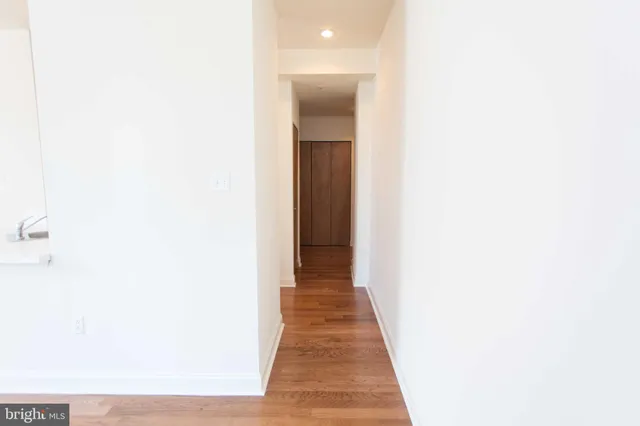 a view of a hallway with wooden floor