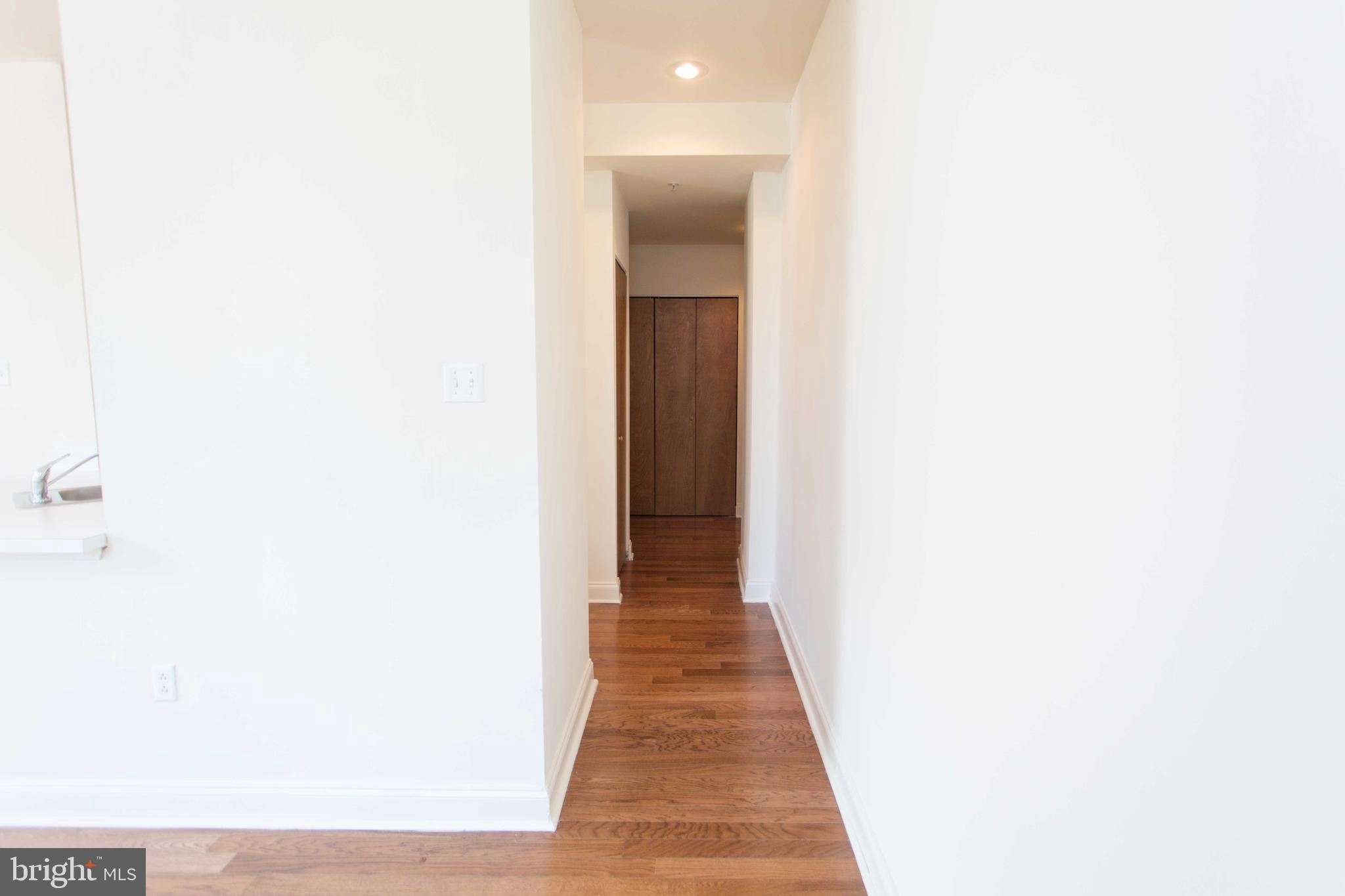 1411-3 Walnut Street, Unit 506 Philadelphia, PA 19102 - Photo 9 of 23 a view of a hallway with wooden floor