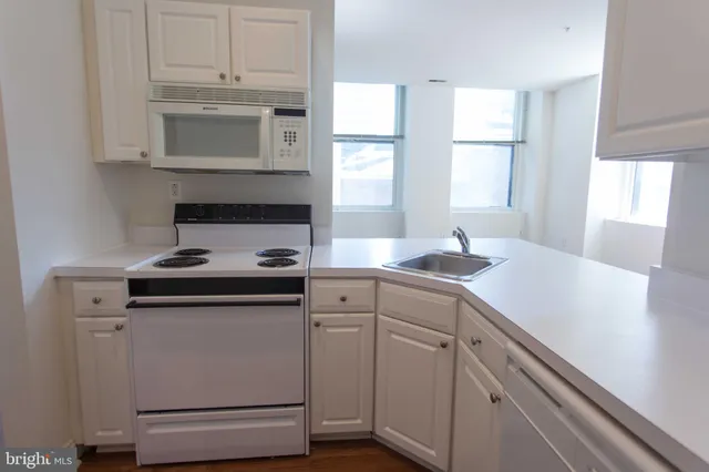 a kitchen with appliances cabinets and a window
