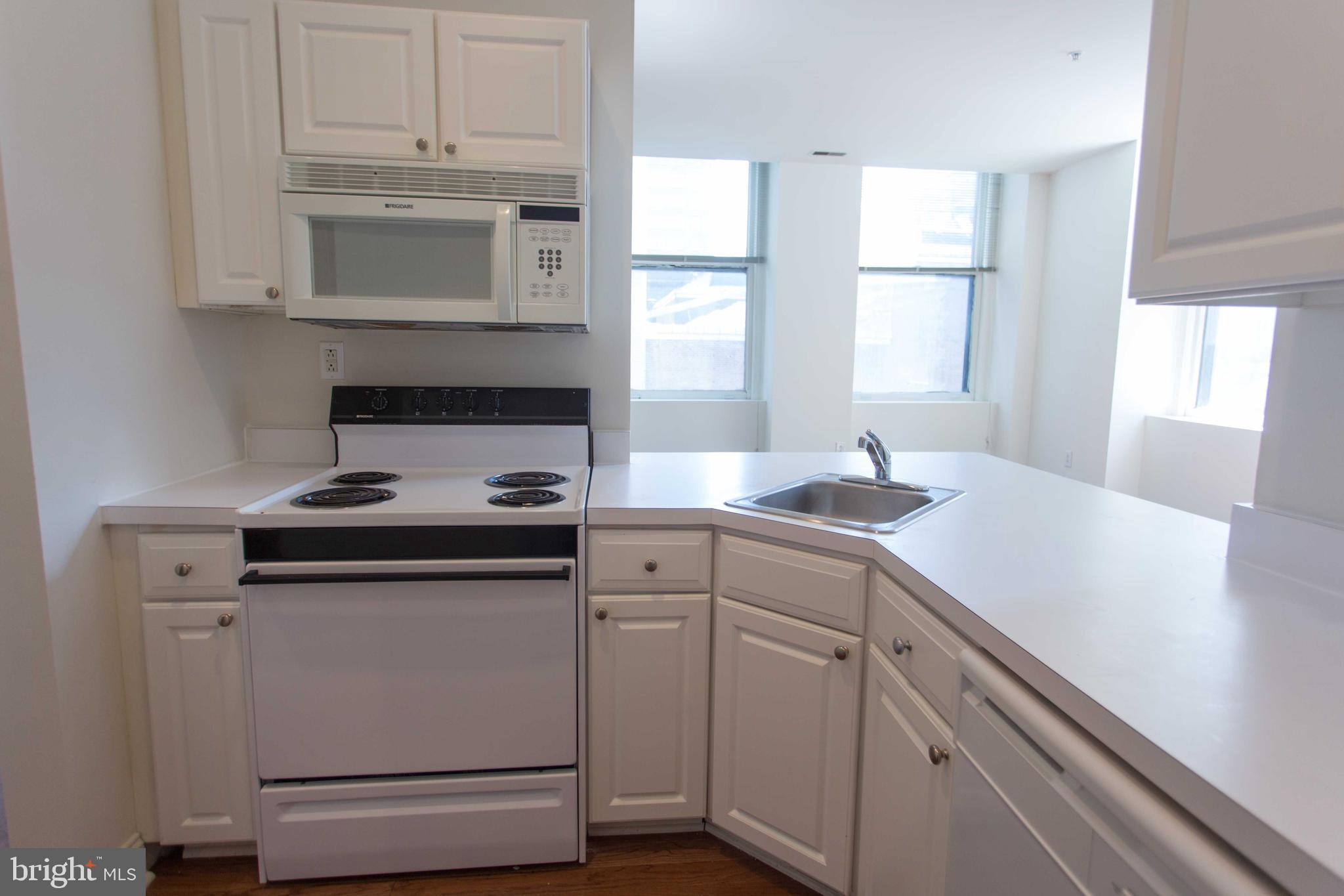 1411-3 Walnut Street, Unit 506 Philadelphia, PA 19102 - Photo 10 of 23 a kitchen with appliances cabinets and a window