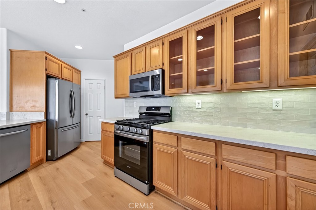 447 Ridgeway Irvine, CA 92620 - Photo 25 of 88 a kitchen with stainless steel appliances granite countertop a stove a sink dishwasher a refrigerator and cabinets with wooden floor