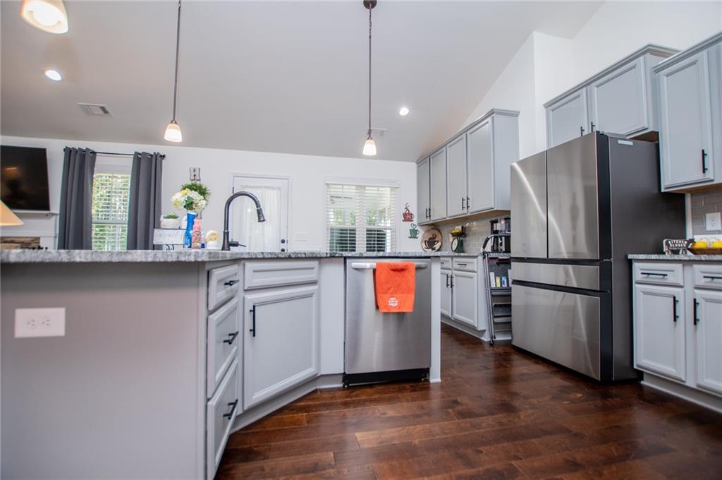 142 Lawrence Drive Villa Rica, GA 30180 - Photo 11 of 80 a kitchen with stainless steel appliances granite countertop a refrigerator a stove a sink and a refrigerator