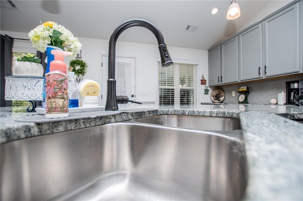 142 Lawrence Drive Villa Rica, GA 30180 - Photo 23 of 80 a view of a kitchen with kitchen island a large counter space stainless steel appliances and cabinets