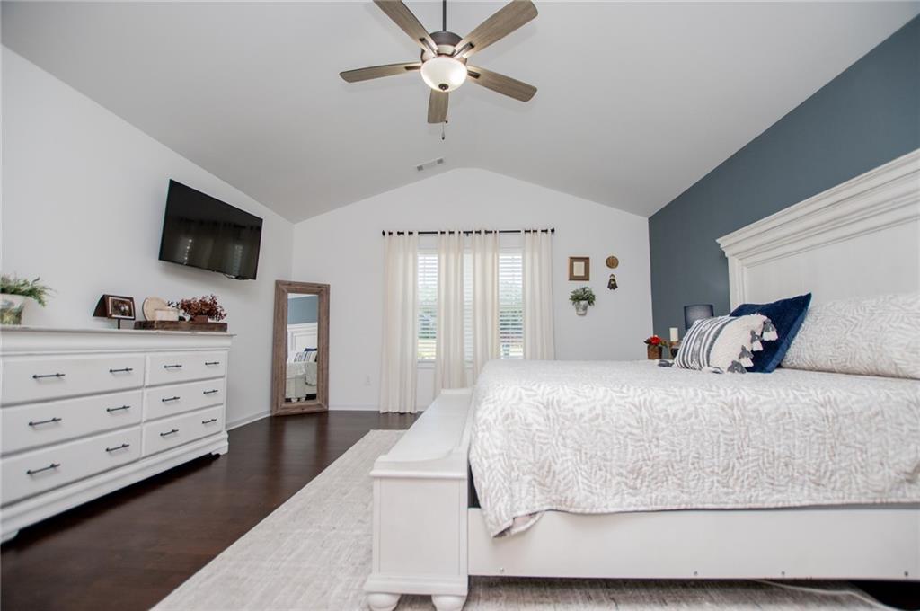 142 Lawrence Drive Villa Rica, GA 30180 - Photo 38 of 80 a bedroom with a large bed and a flat tv screen on dresser