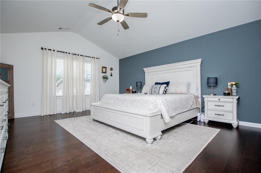 142 Lawrence Drive Villa Rica, GA 30180 - Photo 39 of 80 a bedroom with a large bed and wooden floor