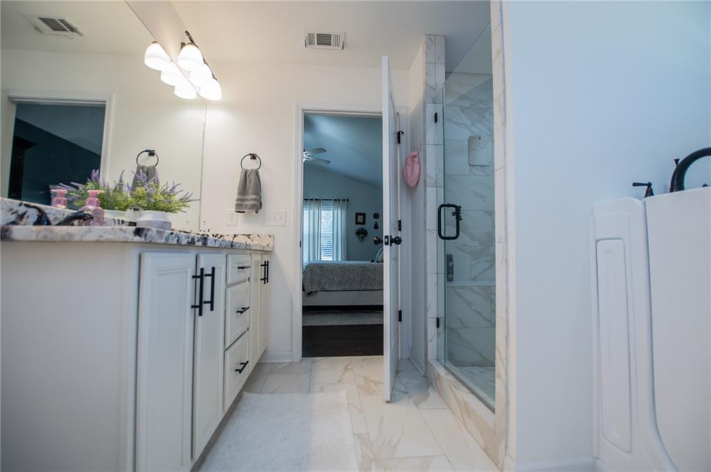 142 Lawrence Drive Villa Rica, GA 30180 - Photo 42 of 80 a bathroom with a double vanity sink mirror and shower