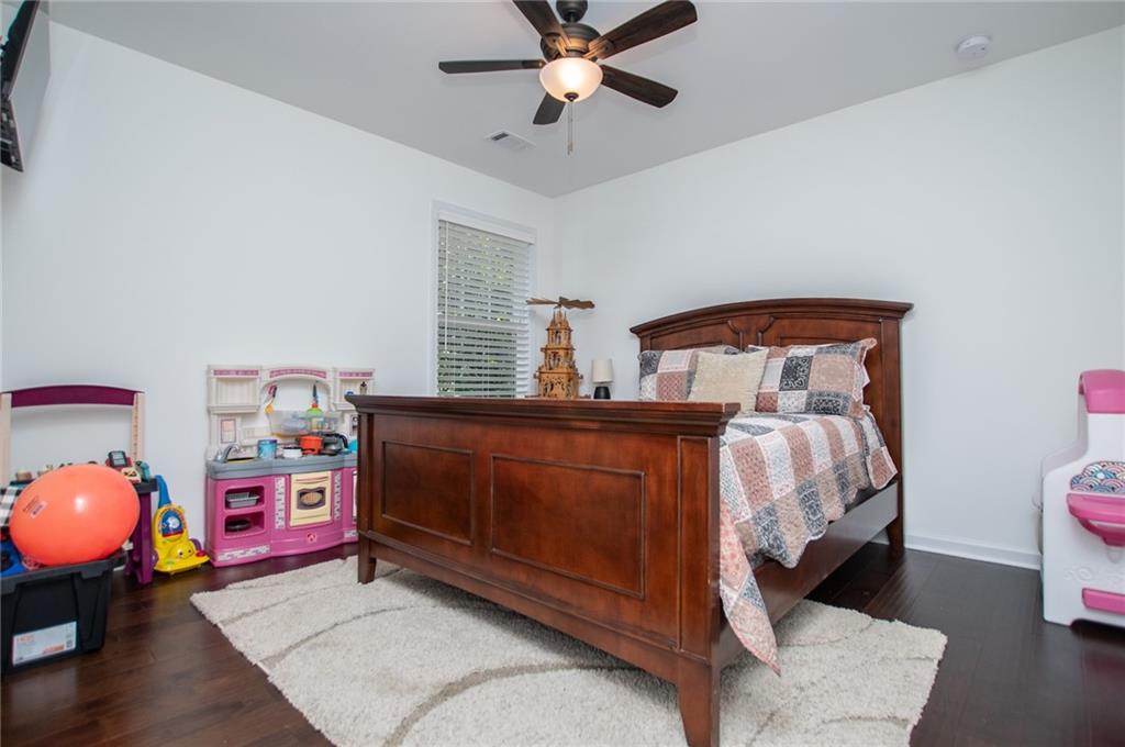 142 Lawrence Drive Villa Rica, GA 30180 - Photo 47 of 80 a bed room with a bed and a chandelier