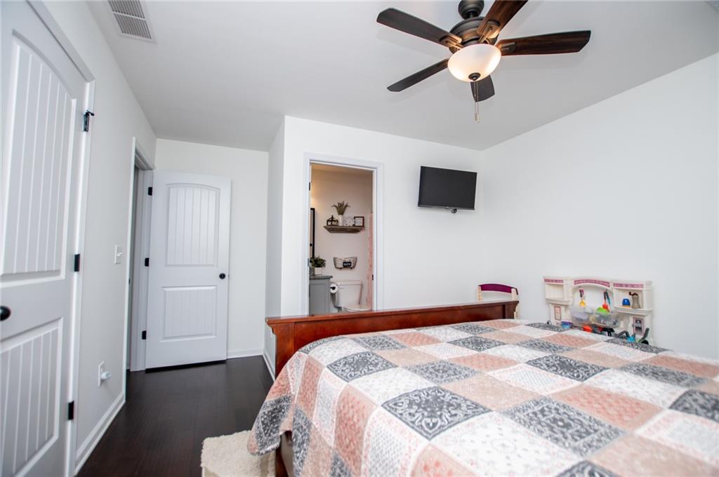 142 Lawrence Drive Villa Rica, GA 30180 - Photo 48 of 80 a bedroom with a bed and a chandelier