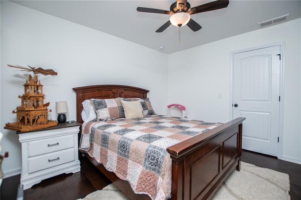 142 Lawrence Drive Villa Rica, GA 30180 - Photo 49 of 80 a bedroom with a bed and a chandelier