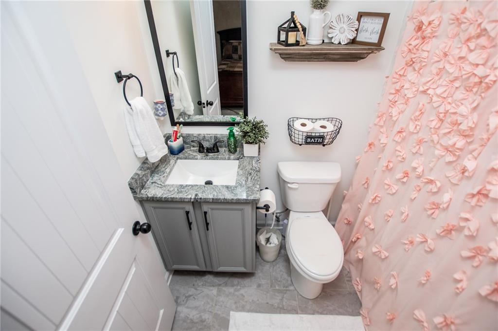 142 Lawrence Drive Villa Rica, GA 30180 - Photo 50 of 80 a bathroom with a toilet a sink and a mirror