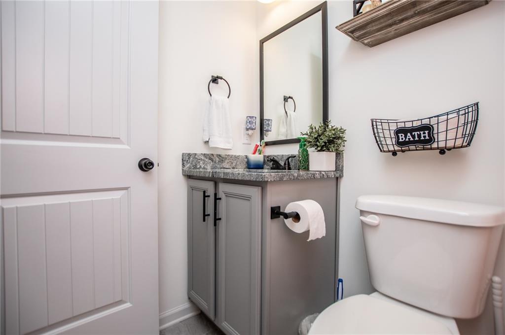 142 Lawrence Drive Villa Rica, GA 30180 - Photo 51 of 80 a bathroom with a toilet a sink and mirror