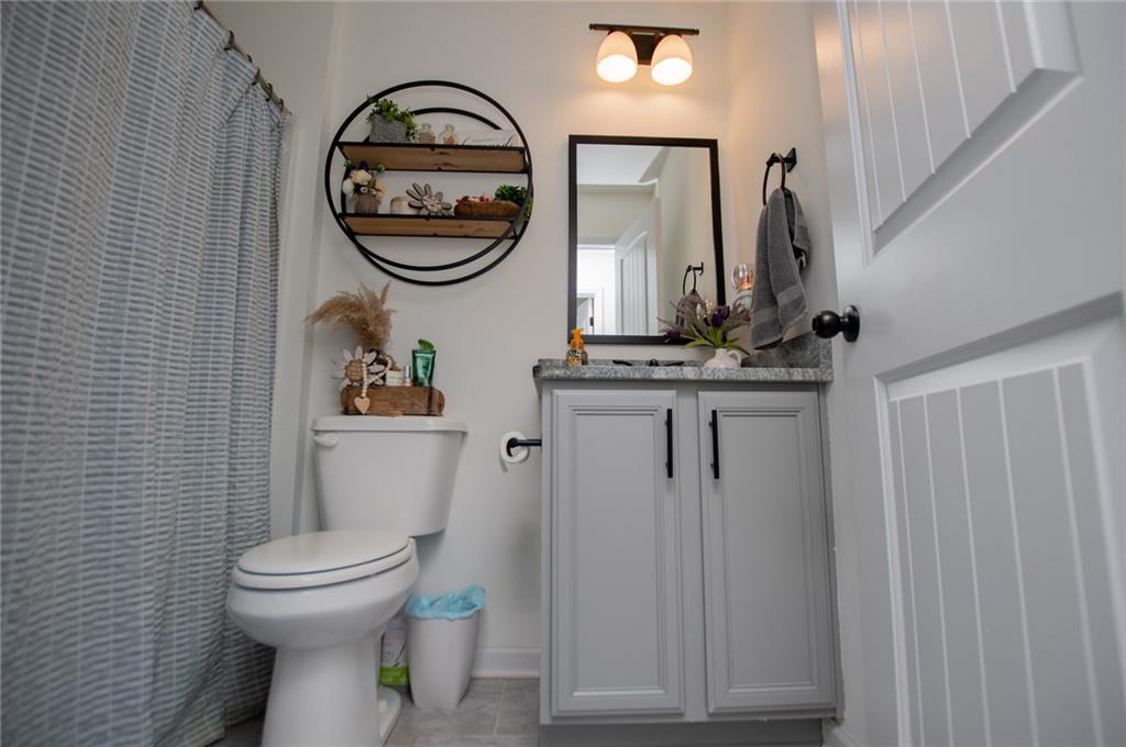 142 Lawrence Drive Villa Rica, GA 30180 - Photo 57 of 80 a bathroom with a toilet a sink and a mirror