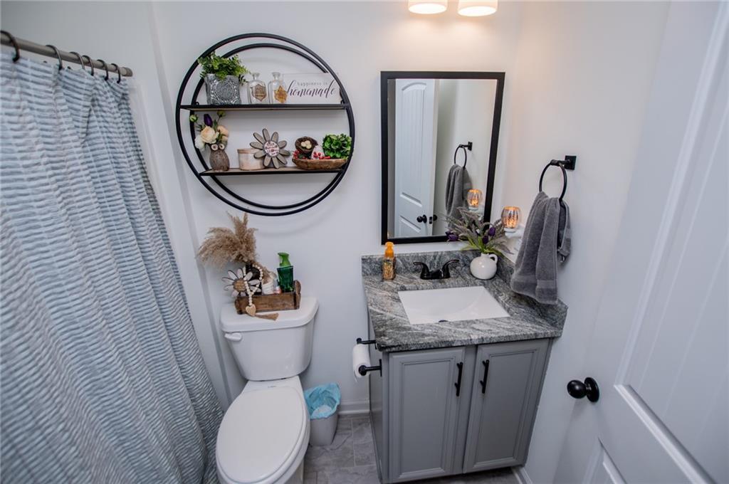 142 Lawrence Drive Villa Rica, GA 30180 - Photo 58 of 80 a bathroom with a toilet a sink and a mirror