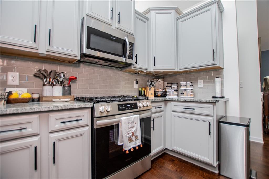 142 Lawrence Drive Villa Rica, GA 30180 - Photo 10 of 80 a kitchen with stainless steel appliances granite countertop a stove a microwave and cabinets