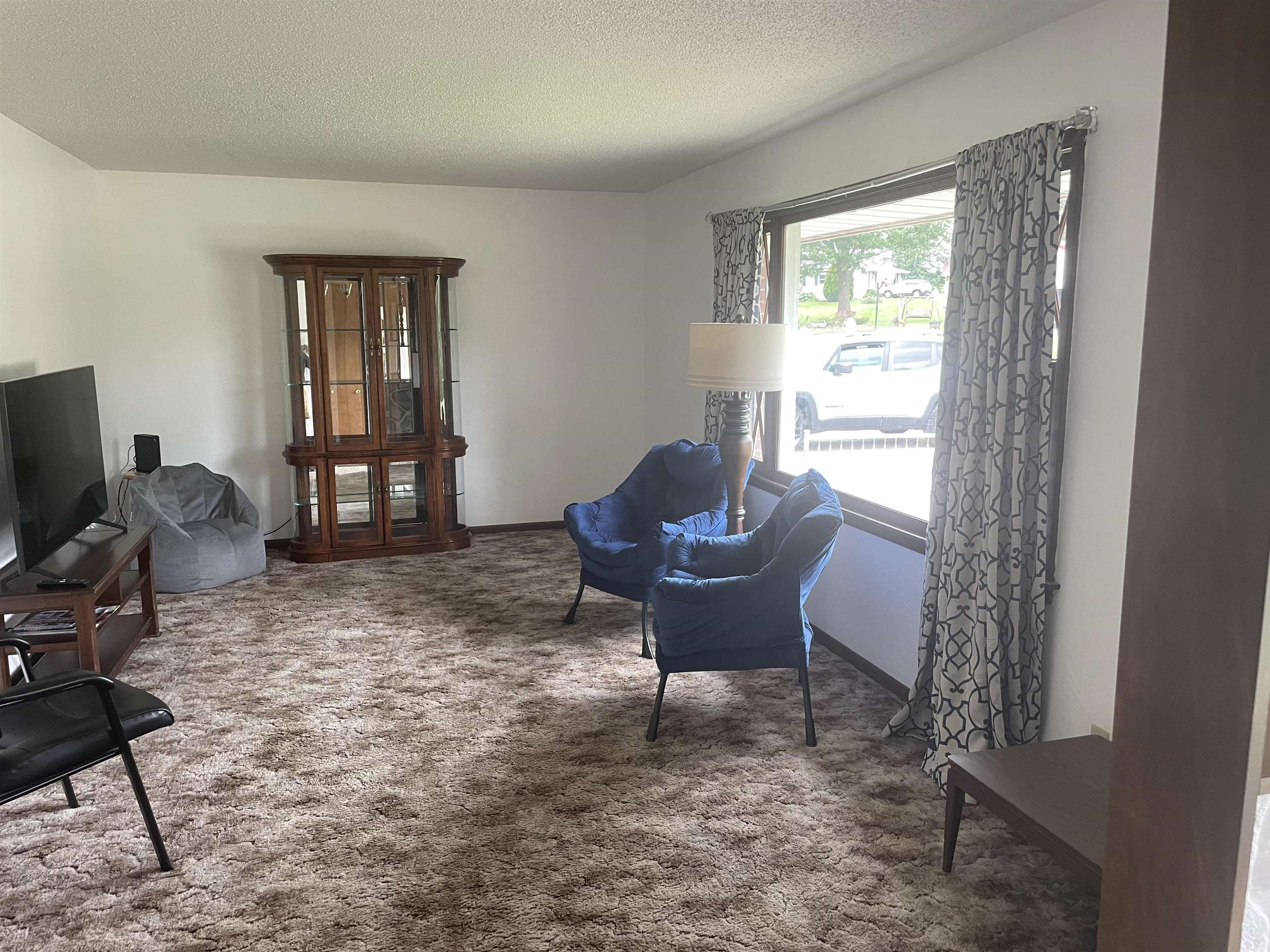 109 Division Street Hanover, IL 61041 - Photo 8 of 28 a living room with furniture a piano and a window