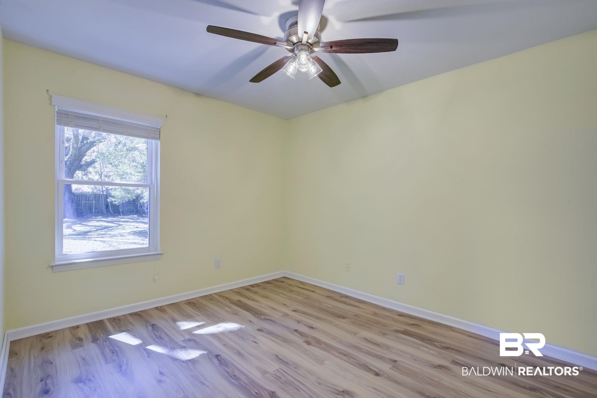 5817 Woodgate Road Mobile, AL 36609 - Photo 51 of 85 Unfurnished room featuring light wood-type flooring, a ceiling fan, and baseboards