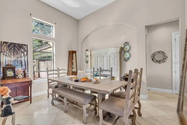 a dining room with furniture and a large window
