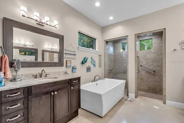 a spacious bathroom with a sink a large mirror and a shower